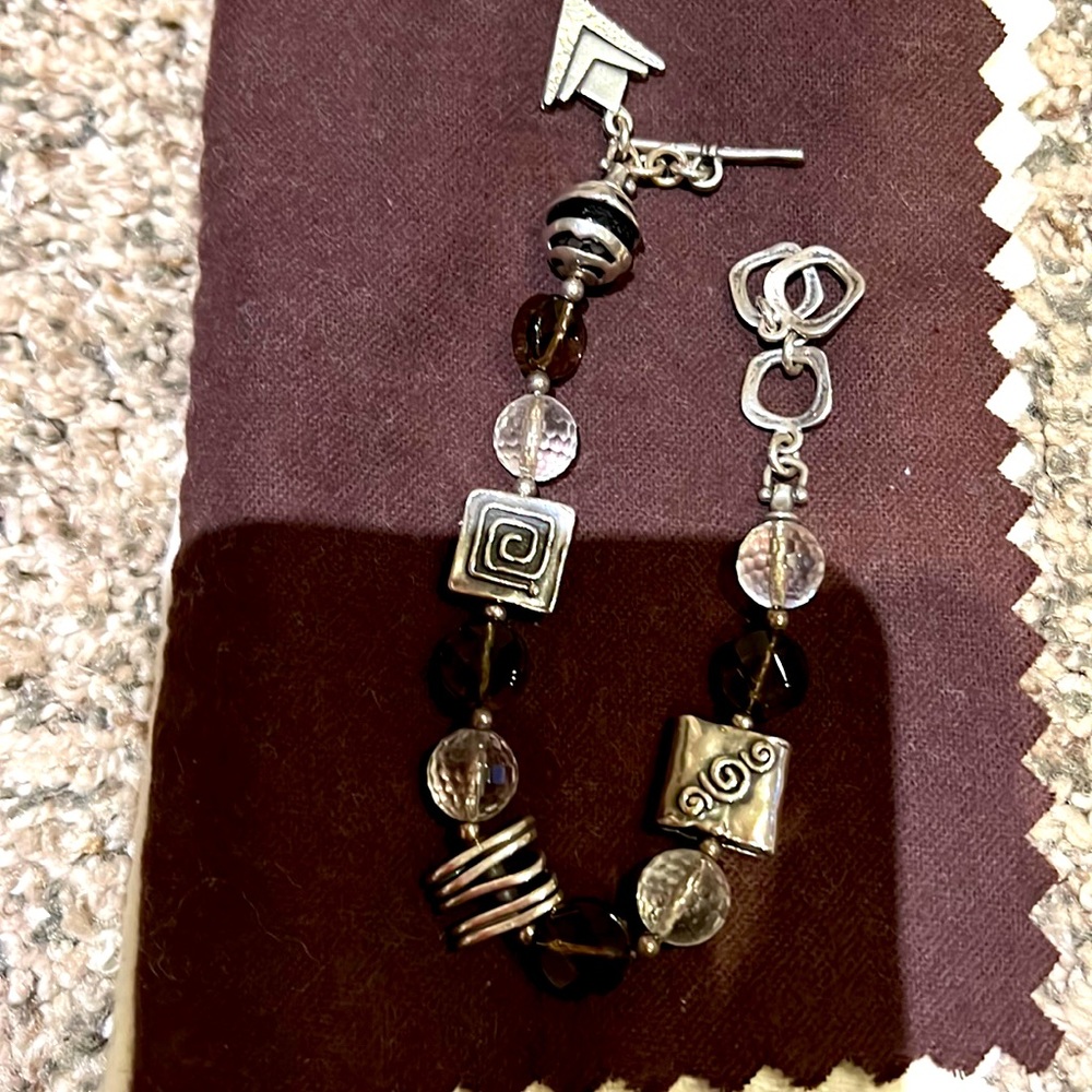 Bracelet w/ toggle closure. Sterling Silver with clear & brown beads.